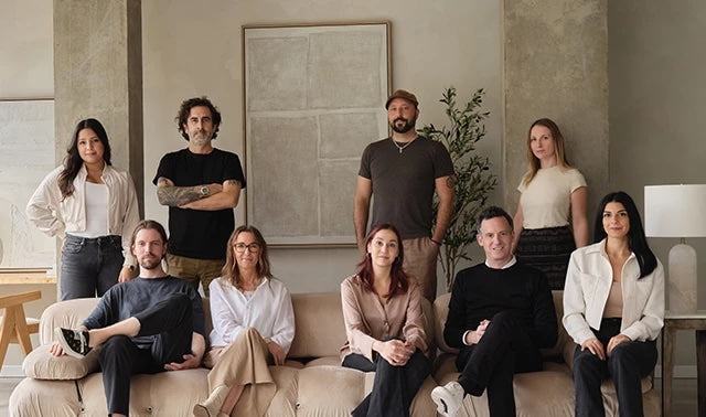 The Renwil team of artists standing together in a modern indoor setting