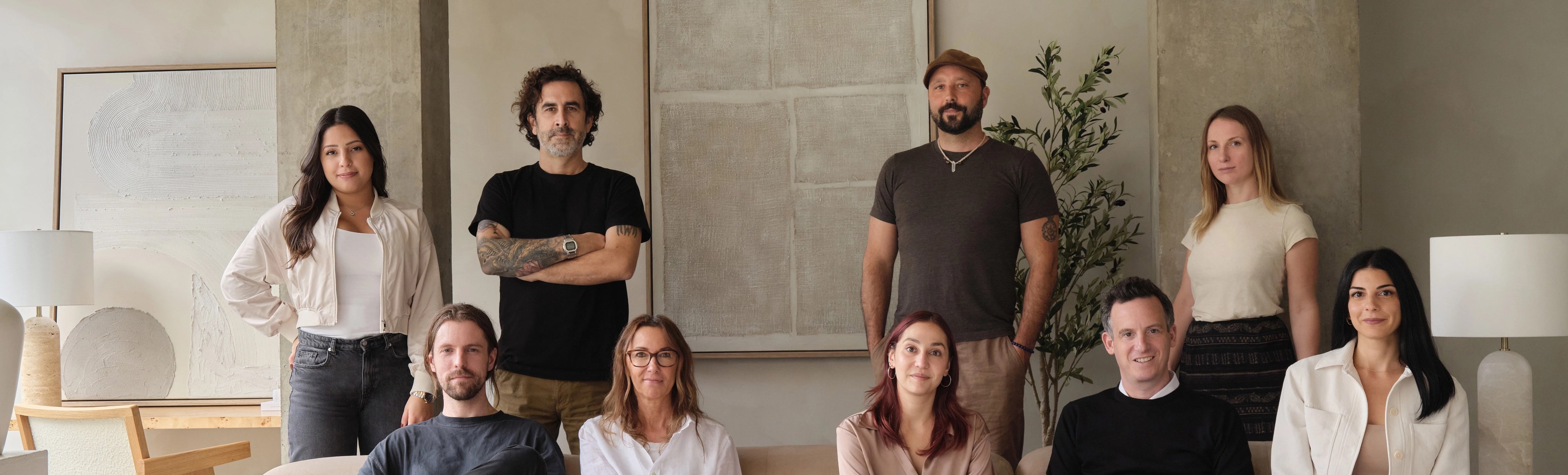 The Renwil team of artists standing together in a modern indoor setting