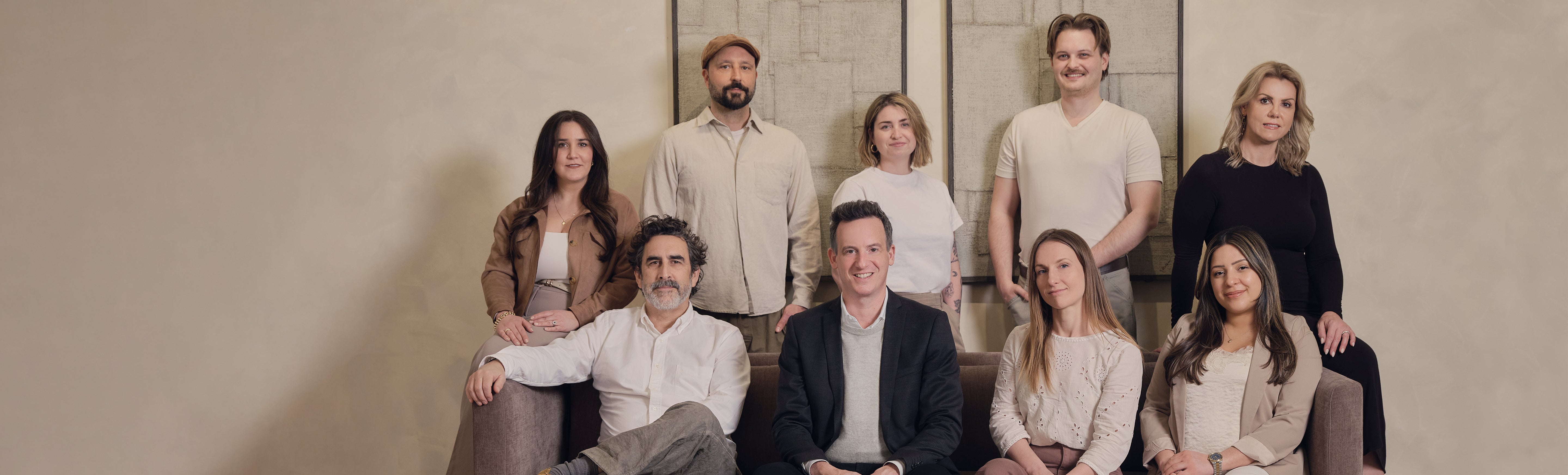 The Renwil team of artists standing together in a modern indoor setting
